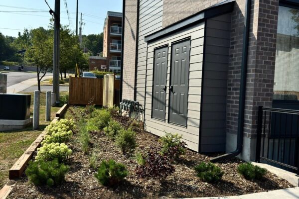 Gardener pulling weeds from flower beds in Orléans Ottawa
